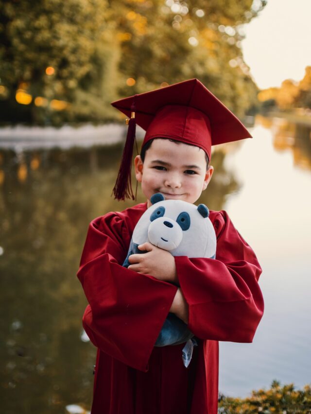 A boy with a teddy and graduation cap